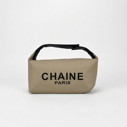 Beige canvas cosmetic pouch with black top handle and CHAINe PARIS logo