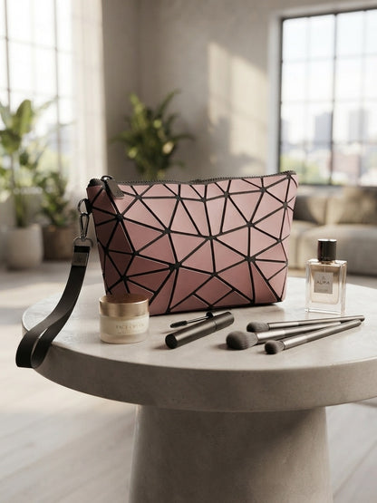 Geometric origami clutch wristlet bag in pink with black geometric pattern and crossbody strap