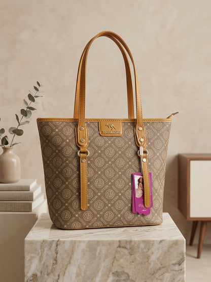 Monogram tote bag with light brown repeating pattern, tan leather handles, and purple charm