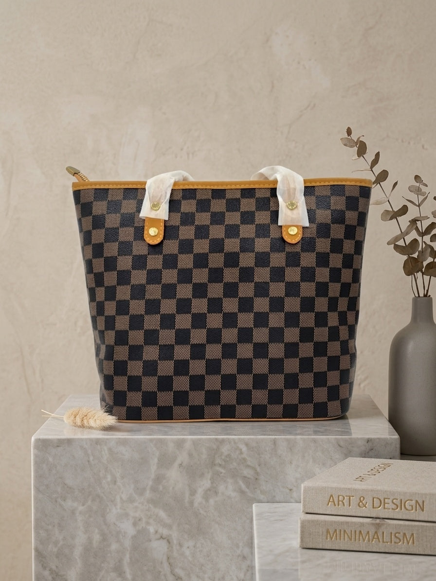 Structured tote bag with dark checkered pattern, tan leather handles, and white tied top
