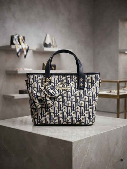 Structured monogram print tote bag with mini pouch charm and two top handles; navy/black
