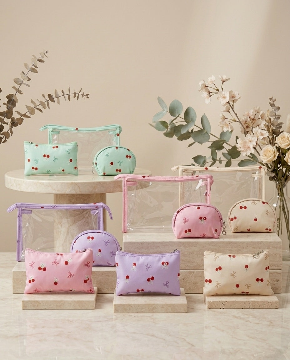 Assorted cherry-print cosmetic pouch sets in mint, lavender, and pink with clear zip organizers