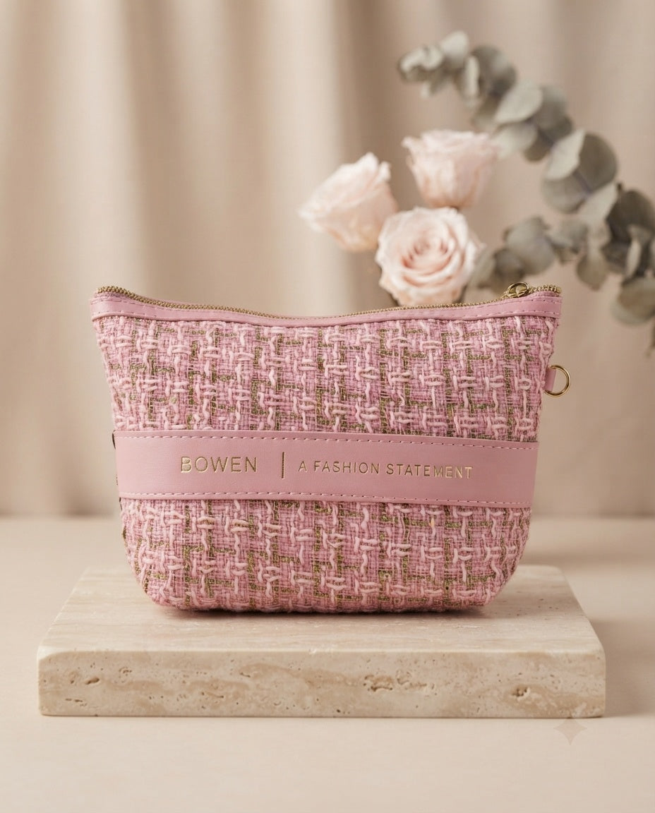 Pink tweed cosmetic pouch with leatherette trim and wristlet strap, top zipper