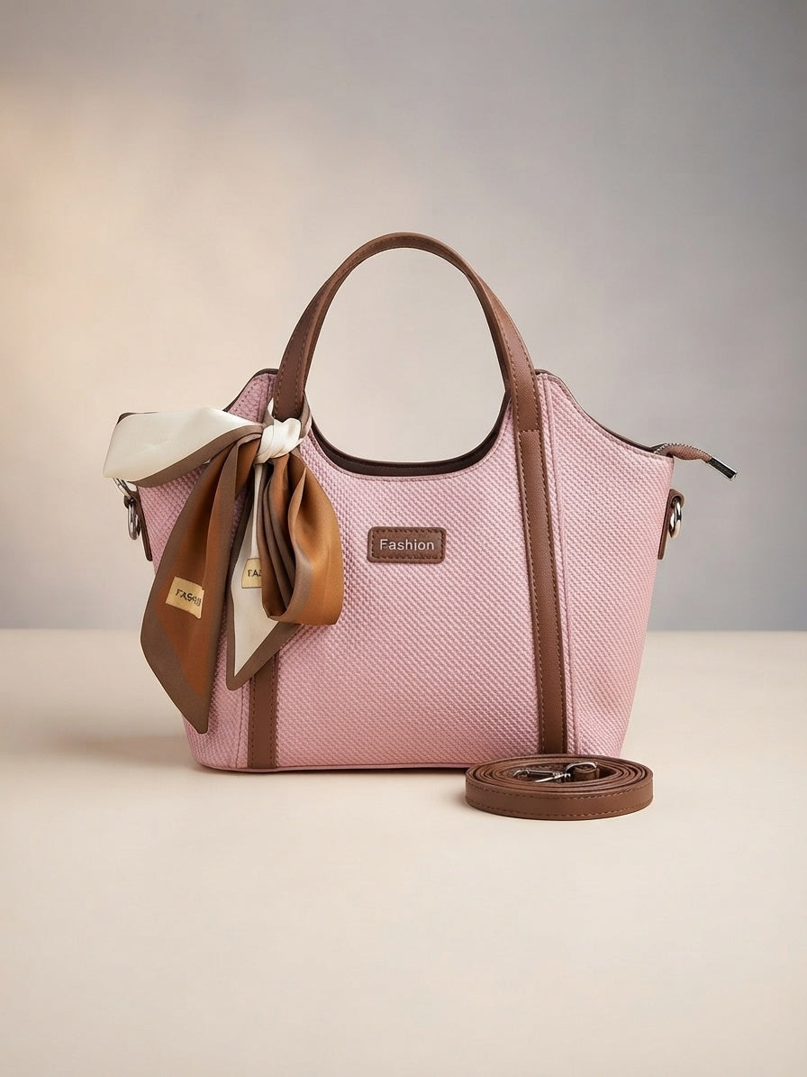 Pink textured structured top-handle bag with bow scarf detail and crossbody strap