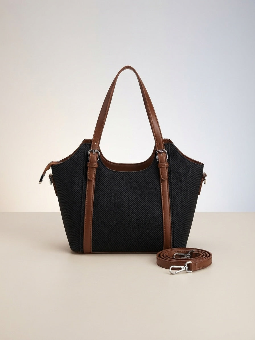 Black textured structured top-handle bag with brown trim and detachable crossbody strap