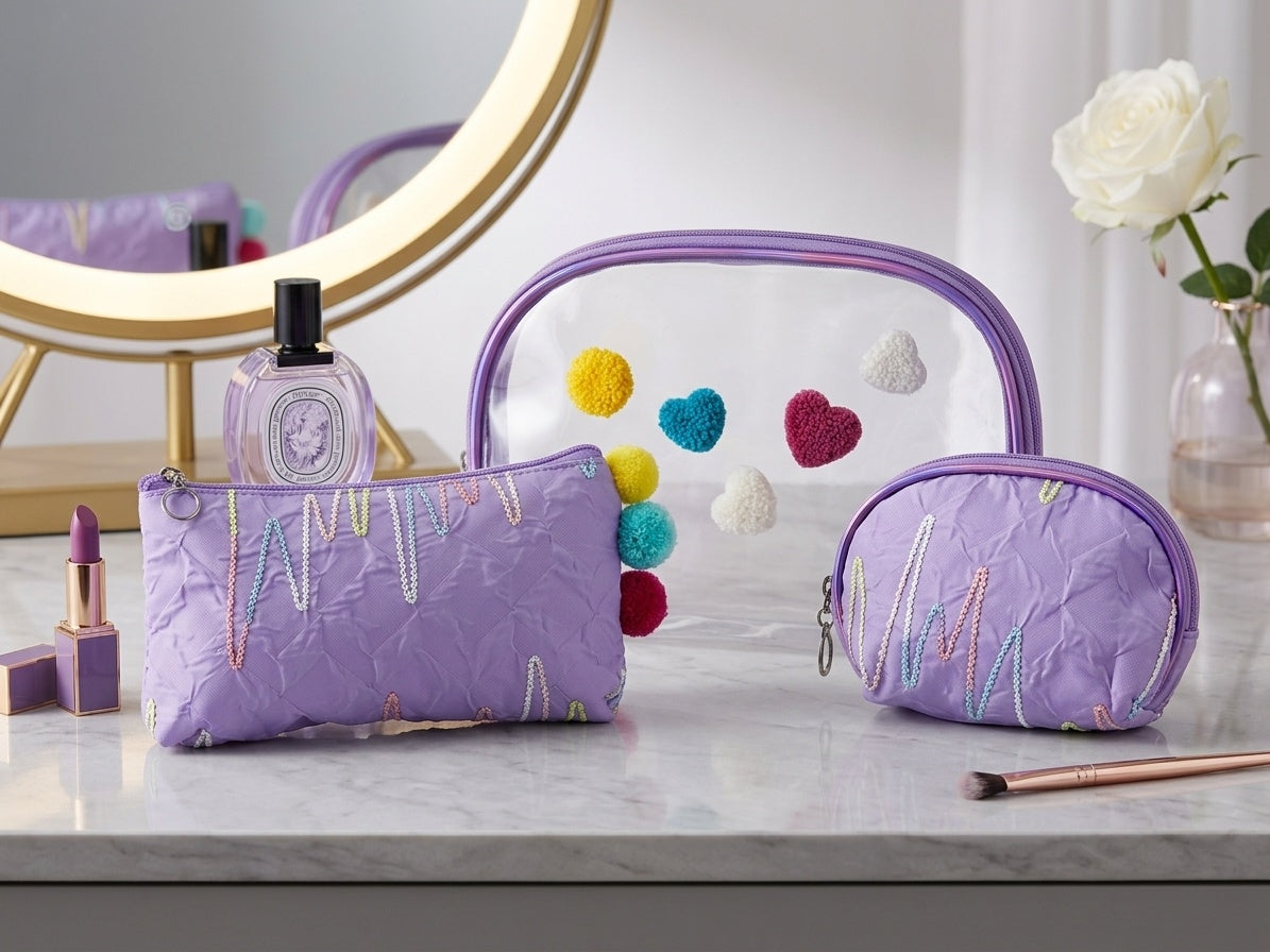 Purple nested clear cosmetic pouches with fuzzy heart appliques and zipper compartments