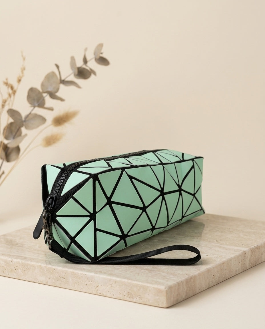 Mint green geometric cosmetic pouch with wristlet strap and zipper, side angle