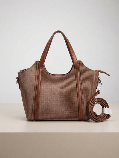 Taupe textured structured top-handle tote with crossbody strap and tassel-style charm