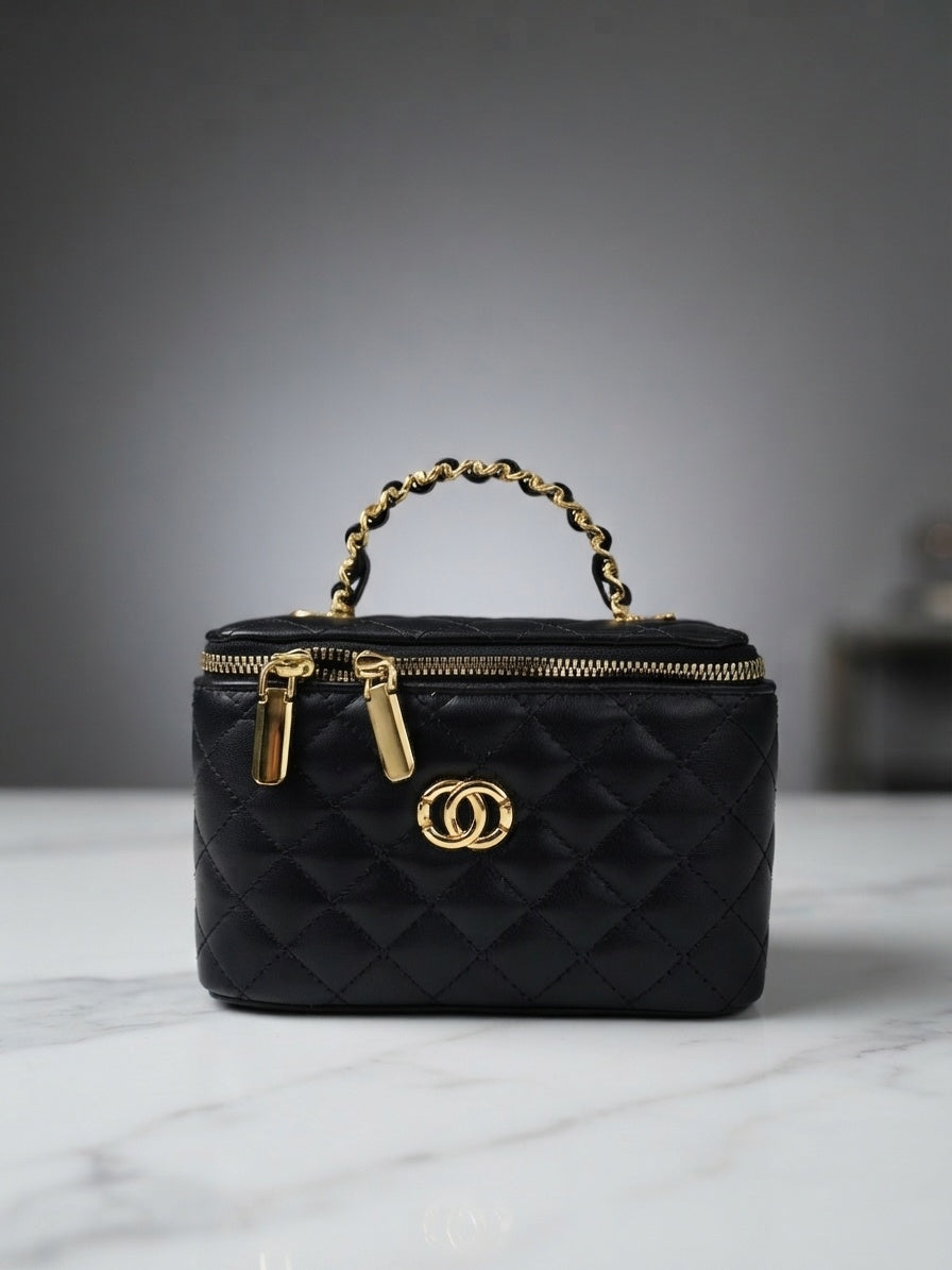 Black quilted vanity cosmetic case with chain handle, top zip, and interlocking CC logo