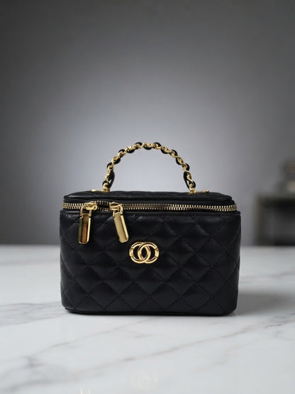 Black quilted vanity cosmetic case with chain handle, top zip, and interlocking CC logo