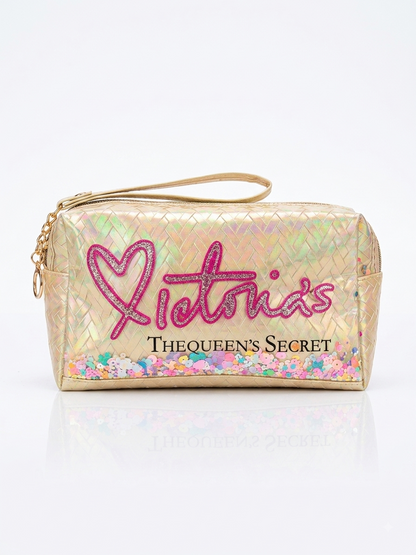Iridescent woven makeup pouch in gold with pink heart logo, top zipper and wrist strap