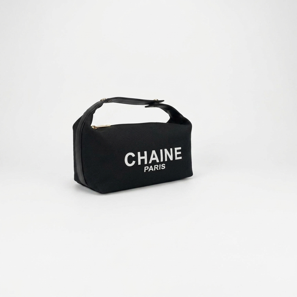Black canvas cosmetic pouch with black top handle and CHAINe PARIS logo