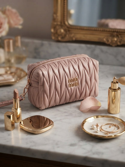 Rose quilted cosmetic pouch with wristlet strap and gold logo, gold zipper pull