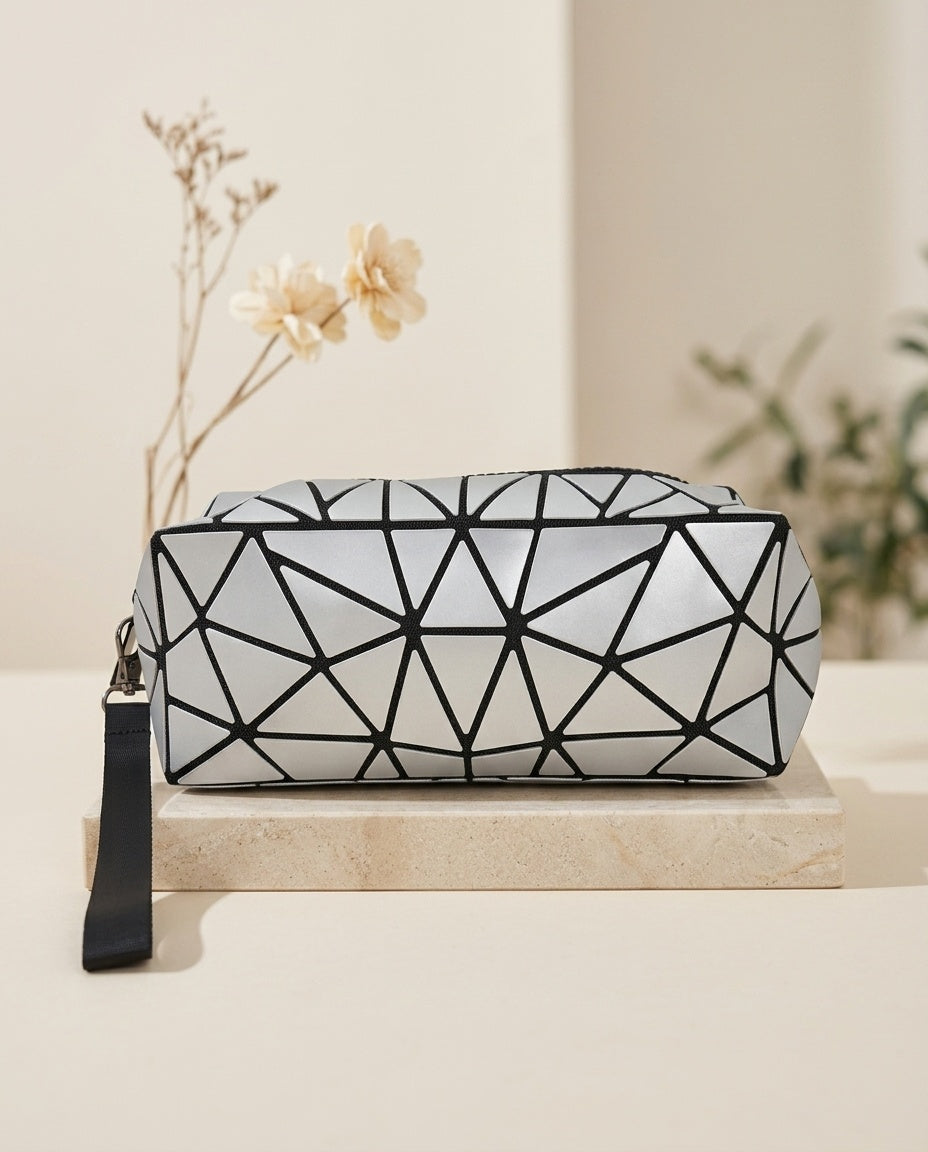 White geometric luminous cosmetic pouch with black zipper and wristlet strap