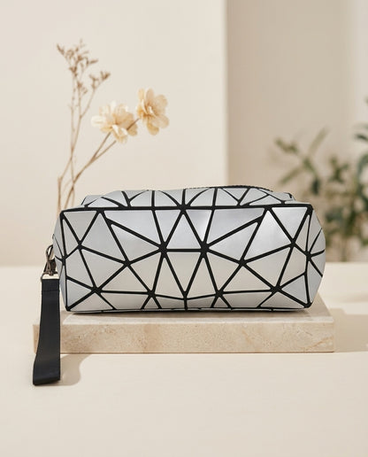 White geometric luminous cosmetic pouch with black zipper and wristlet strap