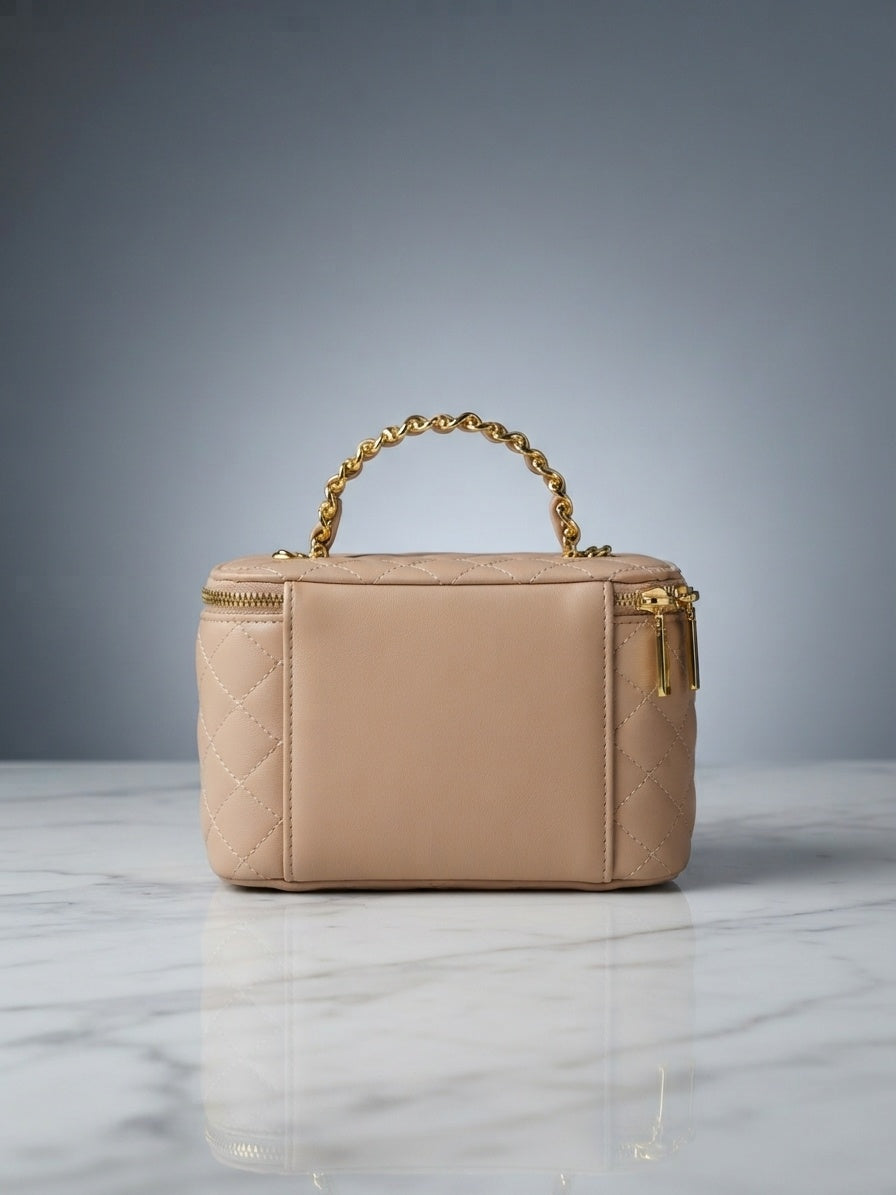 Beige quilted vanity cosmetic case with chain handle and top zip enclosure