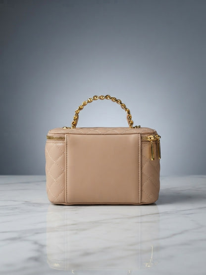 Beige quilted vanity cosmetic case with chain handle and top zip enclosure