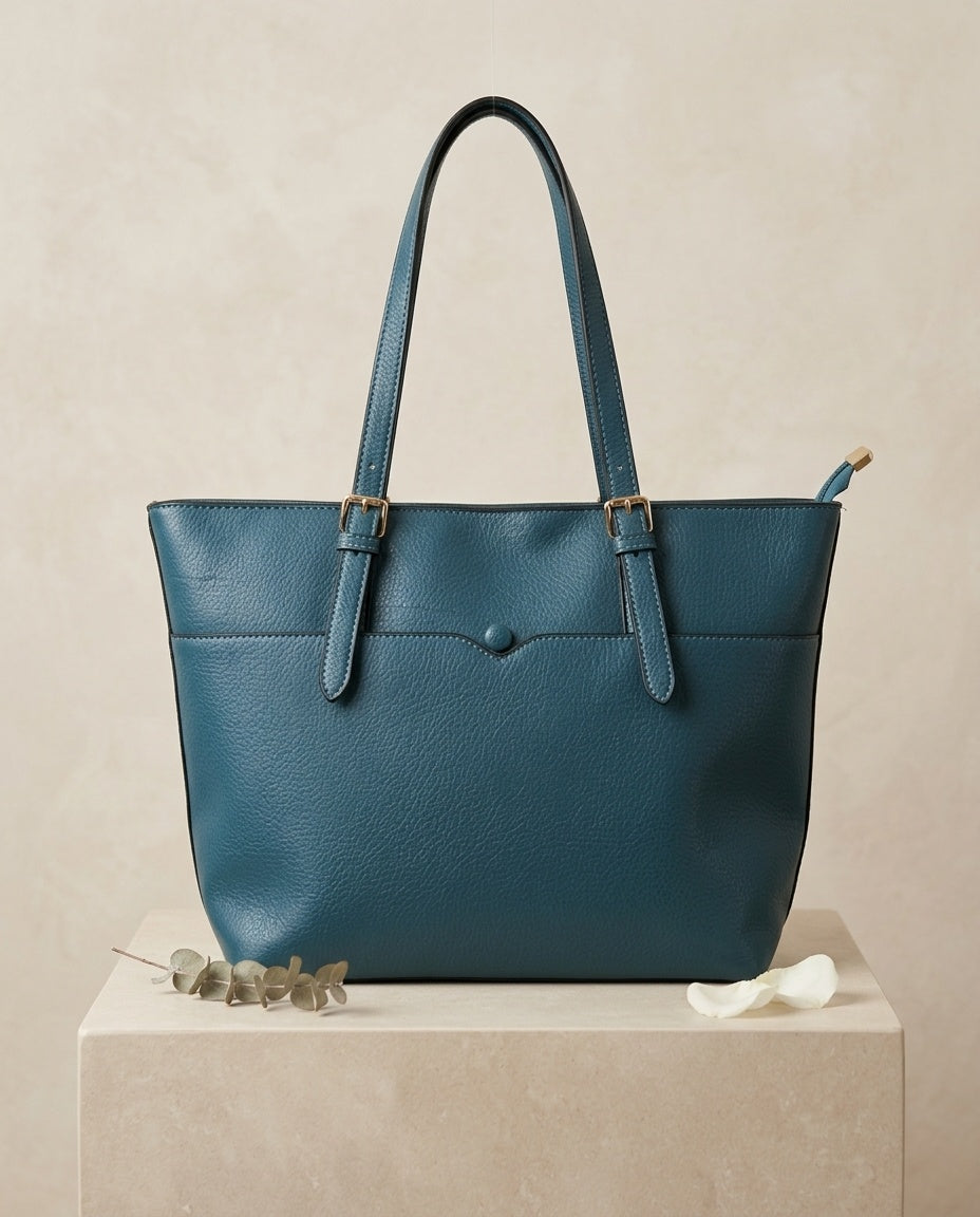 Teal pebbled faux leather tote bag with front pocket and buckle strap handles