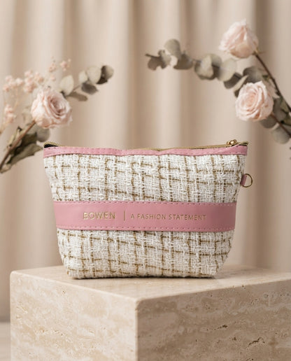 Beige tweed cosmetic pouch with pink leatherette band and wristlet strap, zipper top