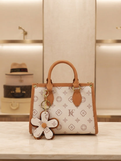 Structured monogram tote bag with flower charm and dangling keychain, white and tan