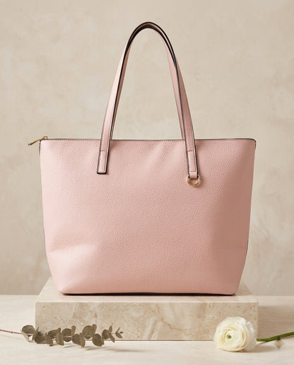 Pebbled faux leather pocket tote bag in light pink with buckle strap handles and front pocket