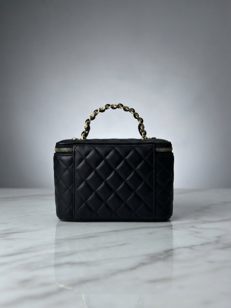 Black quilted vanity cosmetic case with chain handle and top zip enclosure, interlocking CC logo