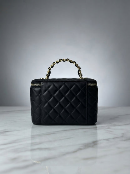 Black quilted vanity cosmetic case with chain handle and top zip enclosure, interlocking CC logo
