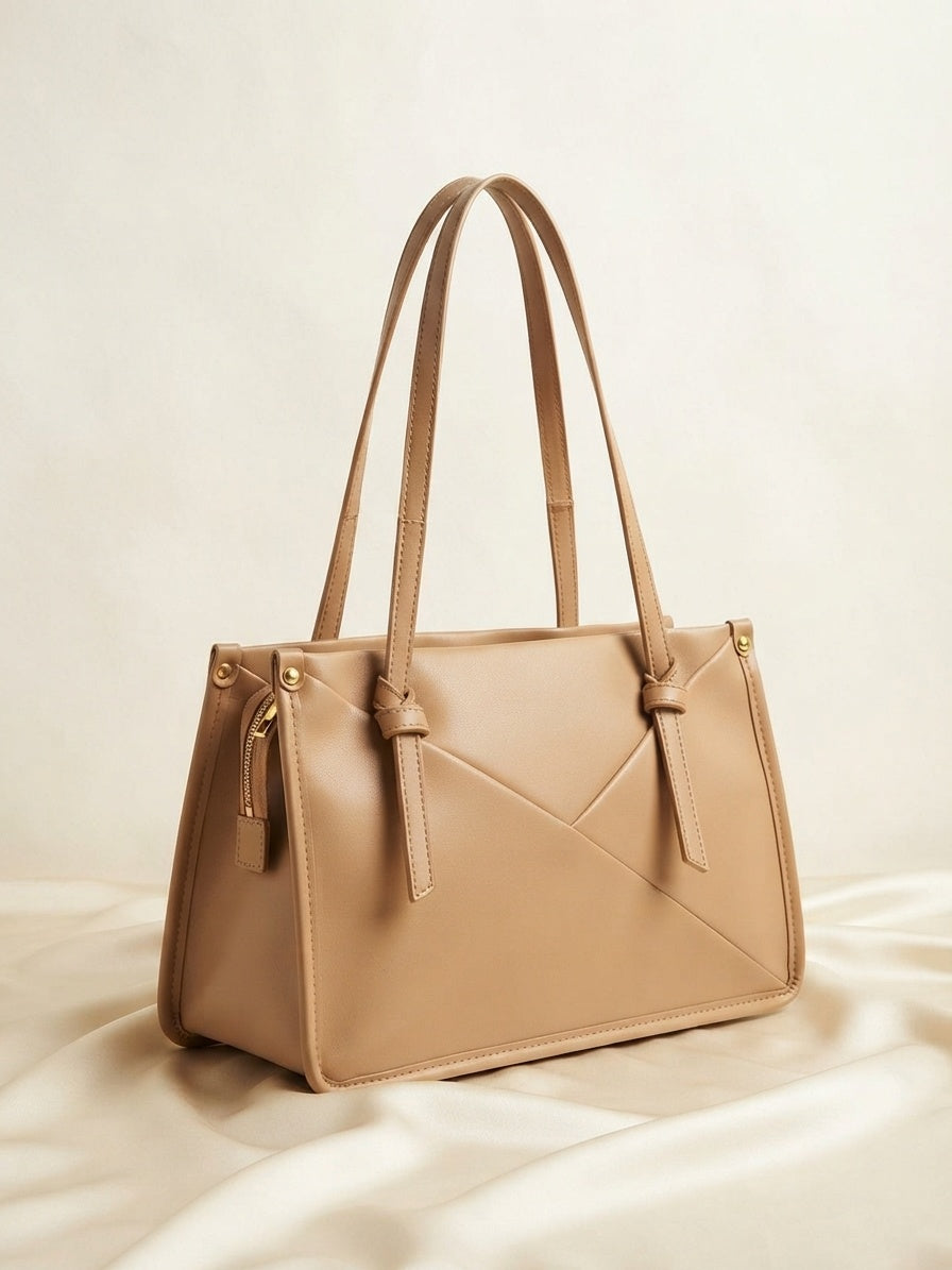 Knot-accent structured shoulder bag in light beige with top handles and diagonal seam