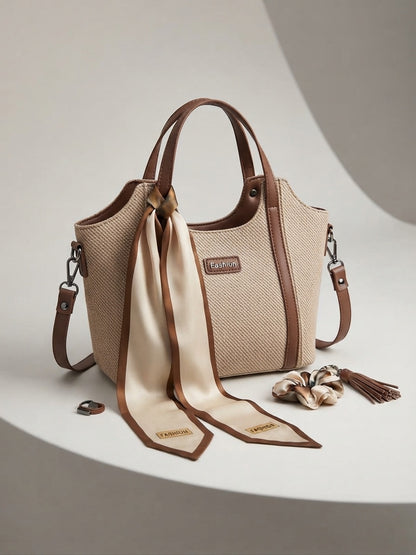 Beige structured top-handle tote with scarf and tassel charm accents, shoulder strap included