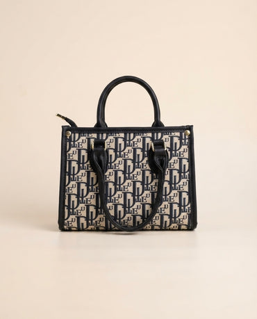 Structured tote bag with navy-and-black logo print, top handles, and front letter pattern