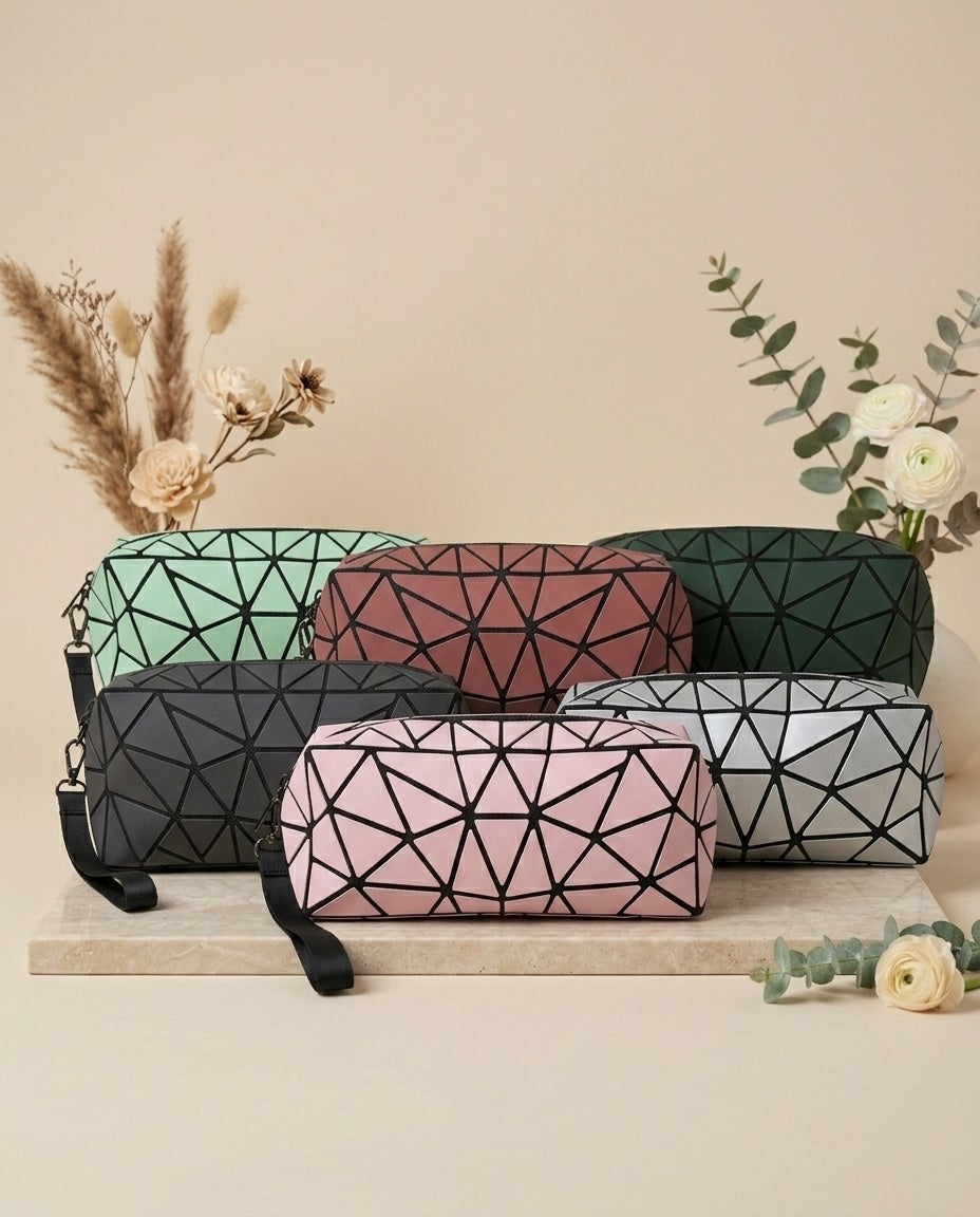 Assorted geometric cosmetic pouches with wristlet straps: green, red, pink, gray