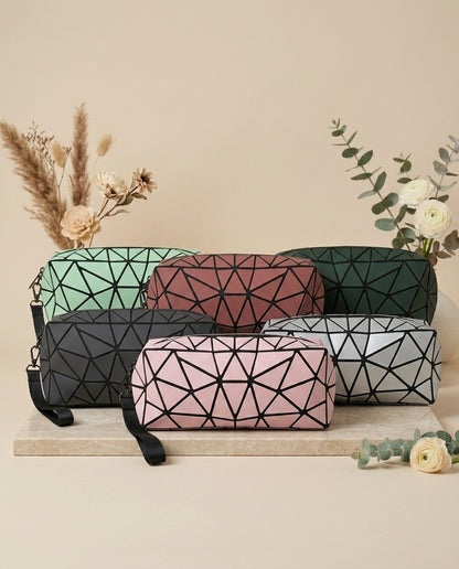 Assorted geometric cosmetic pouches with wristlet straps: green, red, pink, gray