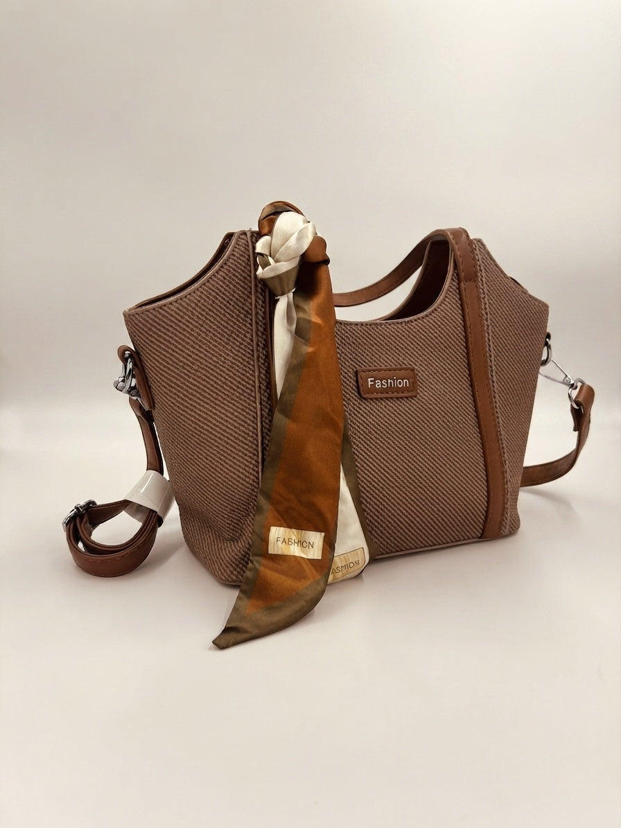 Dark brown textured structured top-handle bag with draped scarf and crossbody strap