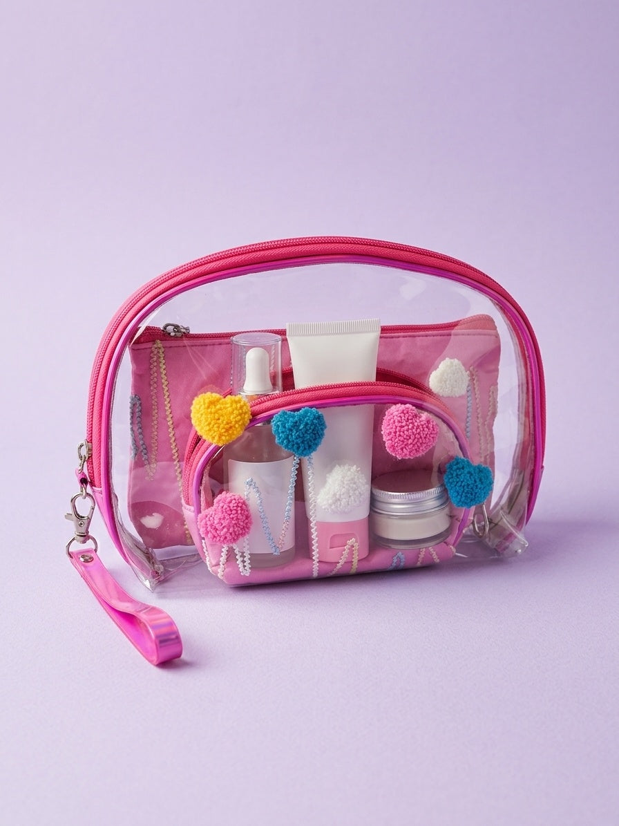 Pink clear nested cosmetic pouches with fuzzy heart appliques and wrist strap