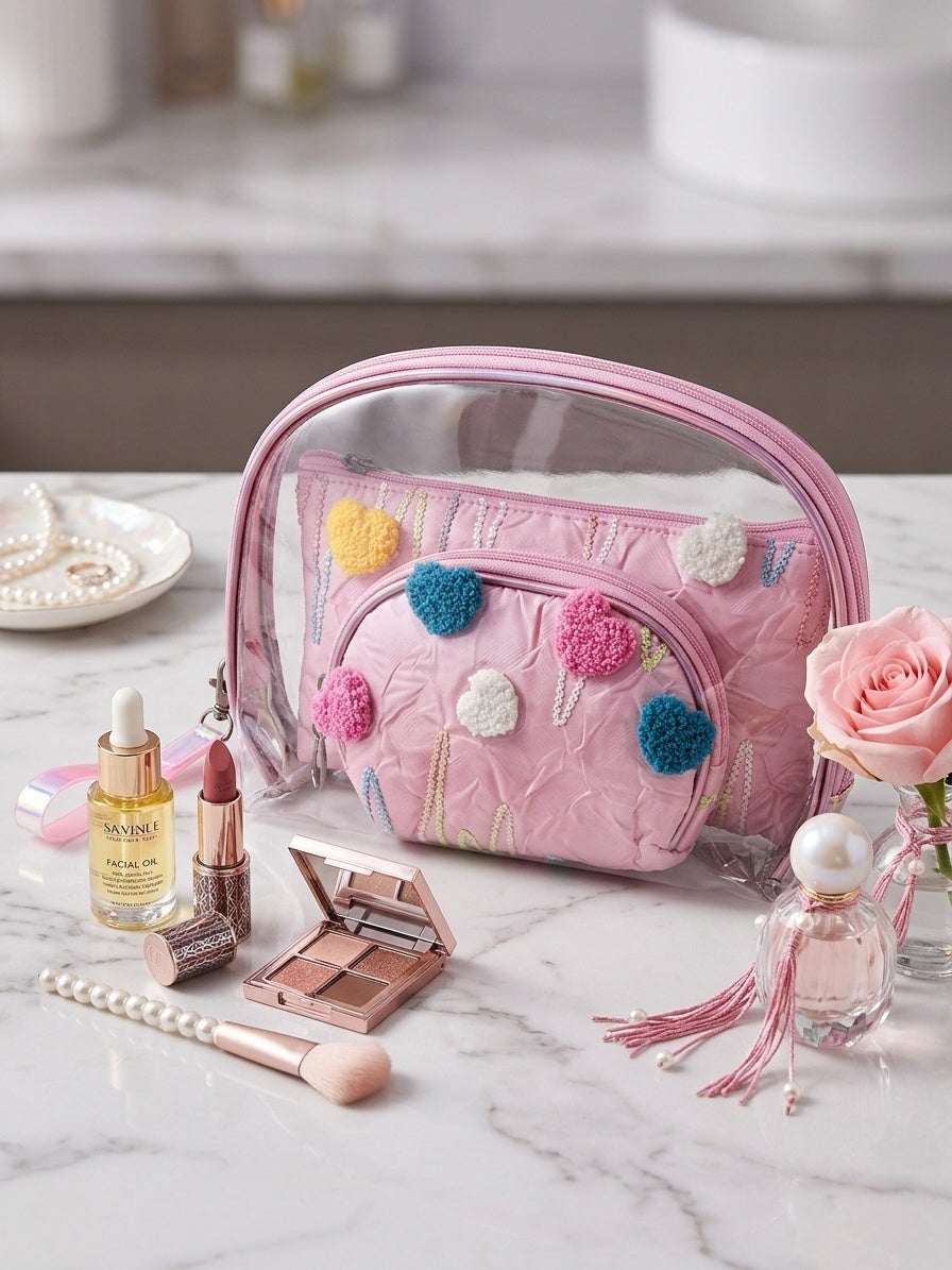 Pink clear nested cosmetic pouch set with fuzzy heart appliques and zipper compartments