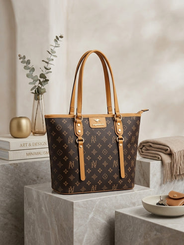 Monogram tote bag with dark brown repeating pattern and tan leather handles