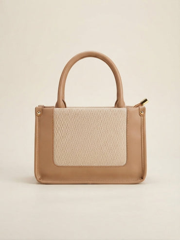 Structured tote bag with beige front flap pocket and tan leatherette handles, with tag charm.