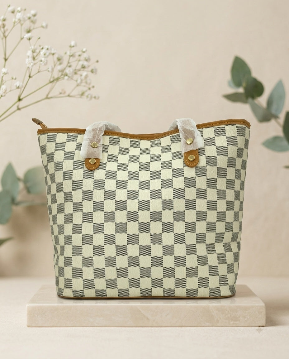 Structured tote bag with light green-and-white checkerboard pattern and tan button straps