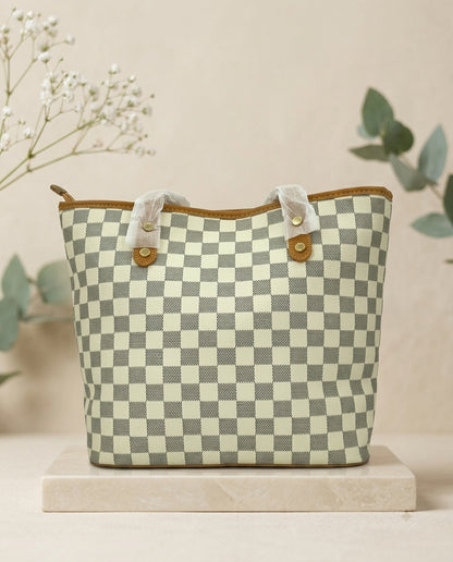 Structured tote bag with light green-and-white checkerboard pattern and tan button straps