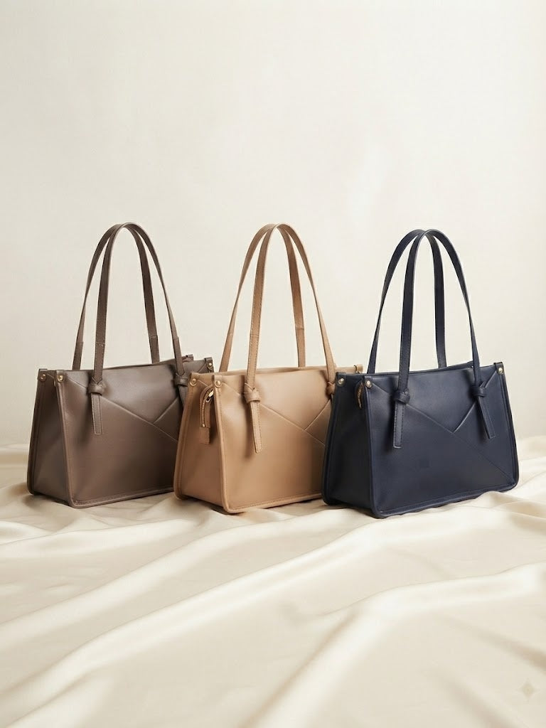 Knot-accent structured shoulder bag set in brown, beige, and navy with top handles